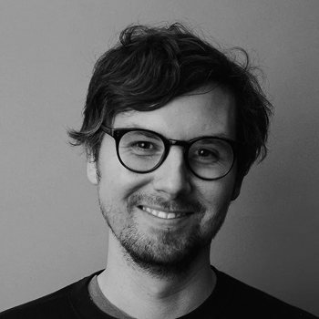 Steve with round glasses, smiling