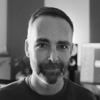 David in his studio, smiling